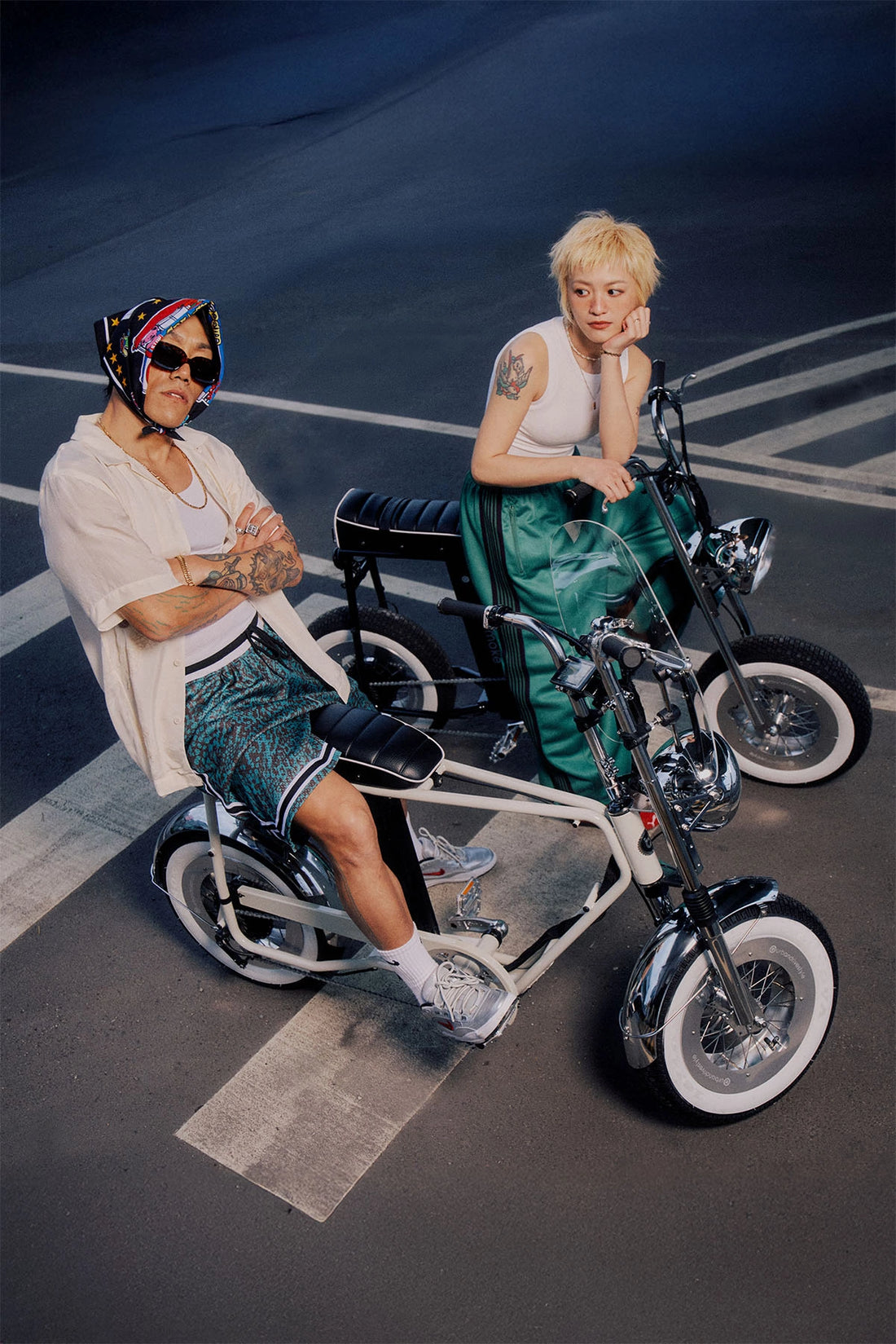 two people riding on the street with a strong street style