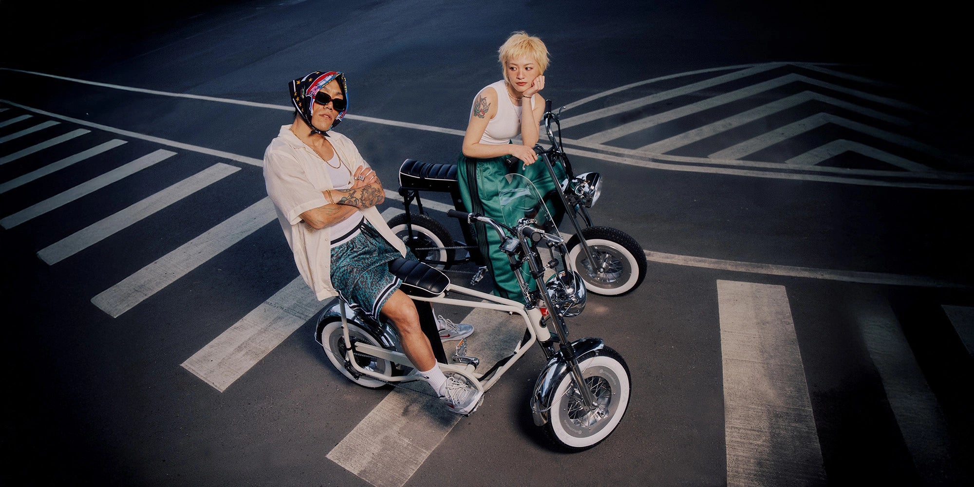 two people riding on the street with a strong street style